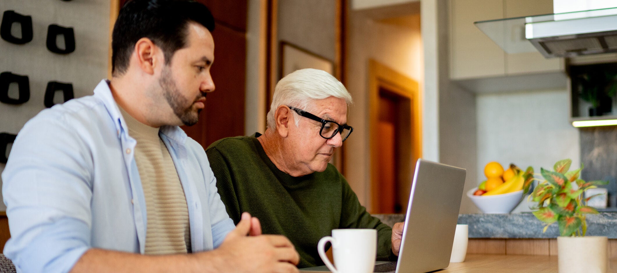 two men sitting at a table talking about a reverse mortgage.