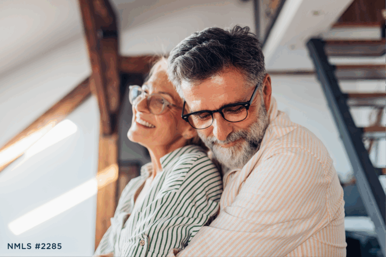 Older couple hugging with financial peace of mind