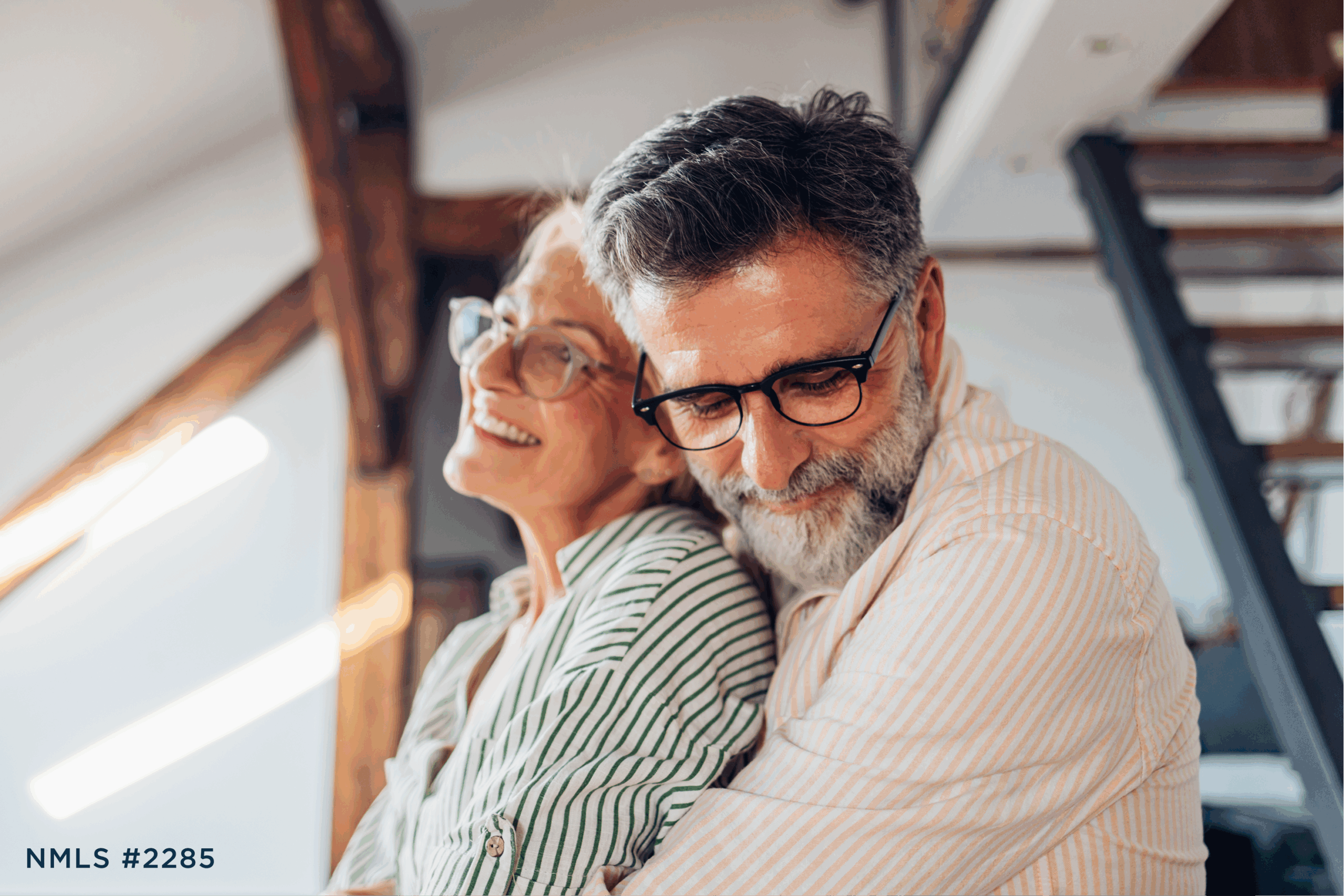 Older couple hugging with financial peace of mind